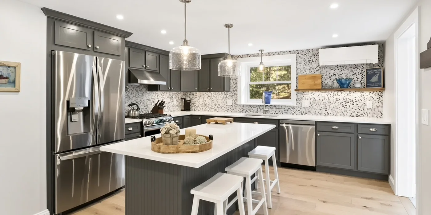 Grey kitchen with quartz island and mosaic tile backsplash